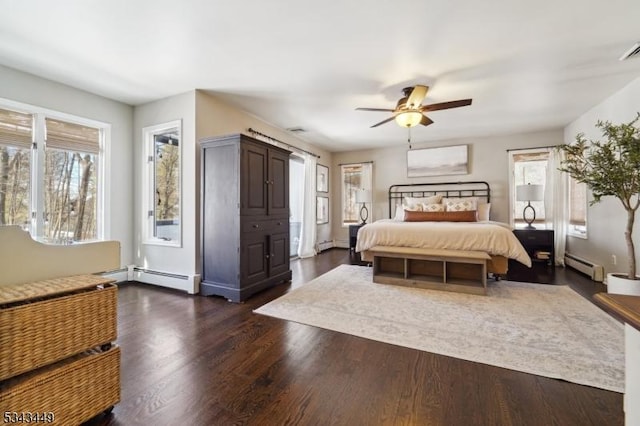 bedroom with ceiling fan, a baseboard radiator, and dark wood finished floors