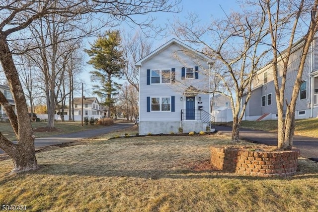 traditional home featuring driveway and a front lawn