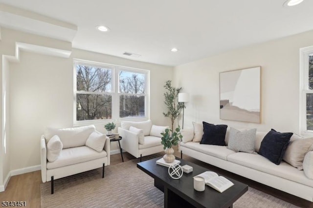 living area featuring recessed lighting, baseboards, and wood finished floors