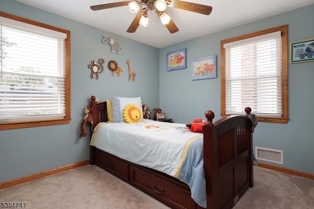 bedroom with light carpet, visible vents, ceiling fan, and baseboards