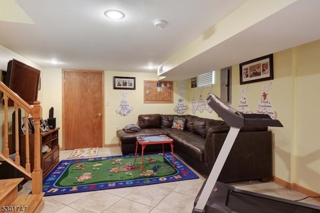 living room featuring light tile patterned floors, baseboards, and stairs