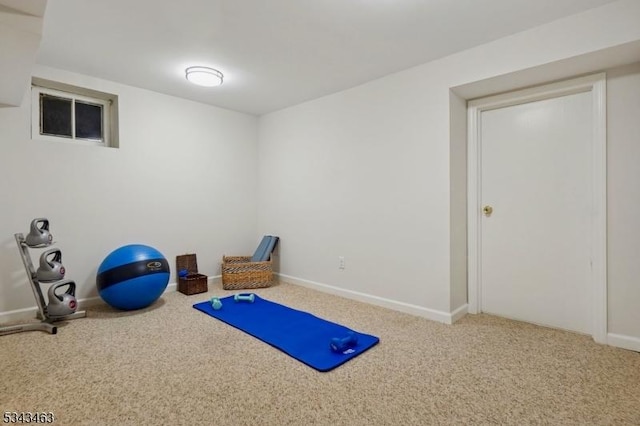 exercise room featuring baseboards and carpet