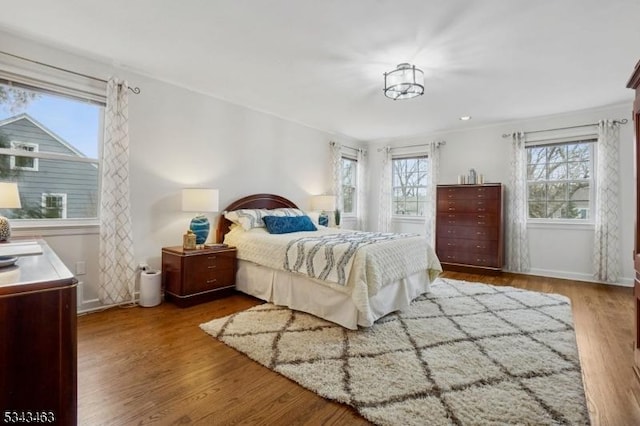 bedroom featuring wood finished floors and baseboards