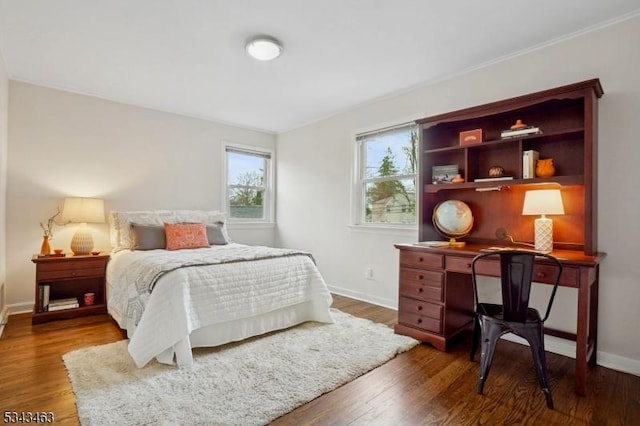 bedroom featuring baseboards and wood finished floors