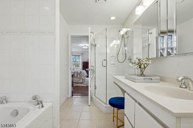 full bathroom with tile patterned flooring, a stall shower, ensuite bath, and a bath