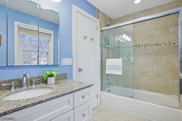 full bath with vanity, tile patterned floors, and combined bath / shower with glass door