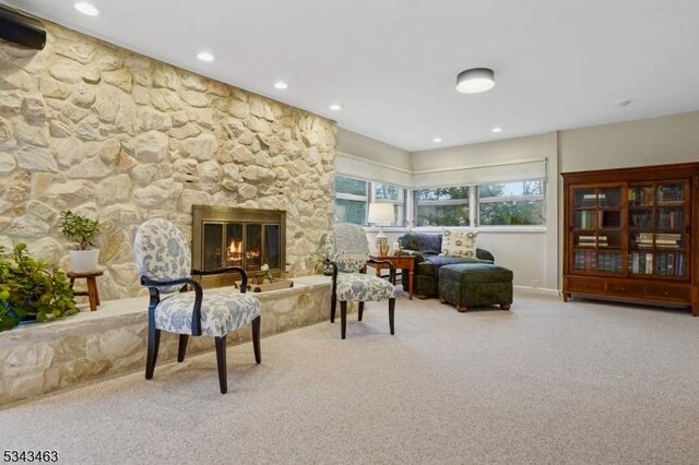 living area featuring carpet, recessed lighting, and a fireplace