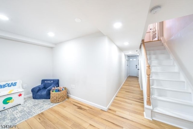 interior space featuring recessed lighting, baseboards, and wood finished floors