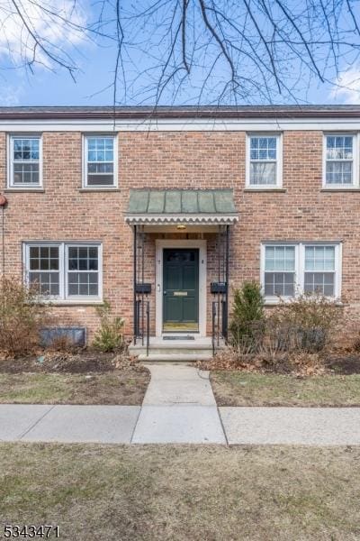 exterior space with brick siding