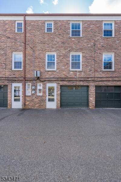 view of property with driveway and an attached garage