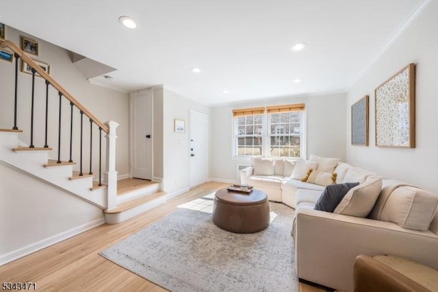 living area with stairway, recessed lighting, baseboards, and wood finished floors