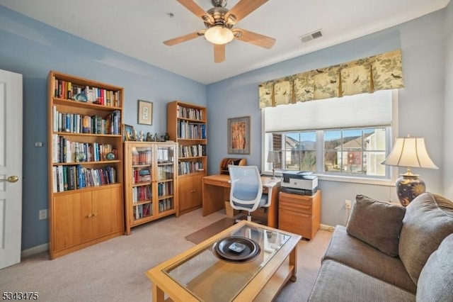 home office with visible vents, carpet flooring, baseboards, and a ceiling fan