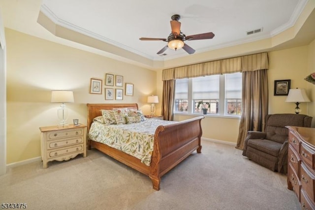 bedroom featuring visible vents, baseboards, ornamental molding, light carpet, and a raised ceiling