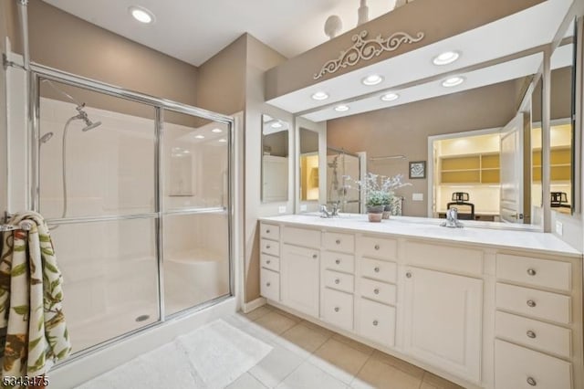 bathroom with tile patterned floors, recessed lighting, a stall shower, and double vanity