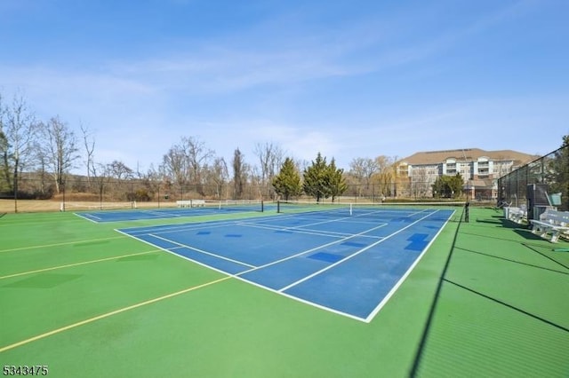 view of sport court featuring fence