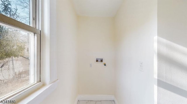 clothes washing area with washer hookup, laundry area, and baseboards