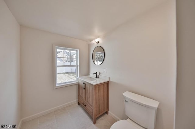 bathroom featuring tile patterned floors, toilet, vanity, and baseboards