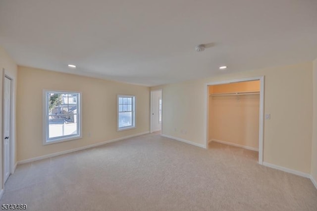 unfurnished bedroom featuring light carpet, recessed lighting, and baseboards