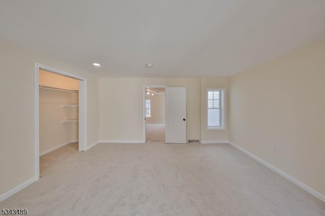 unfurnished bedroom with recessed lighting, baseboards, and light colored carpet