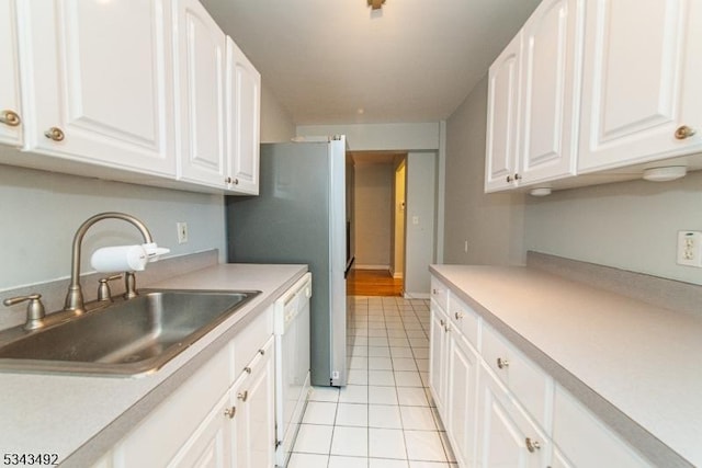kitchen with a sink, light tile patterned floors, and light countertops