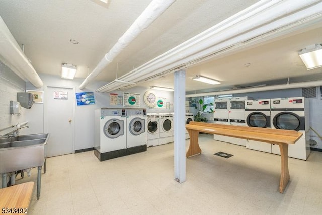 shared laundry room featuring washing machine and clothes dryer and tile patterned floors