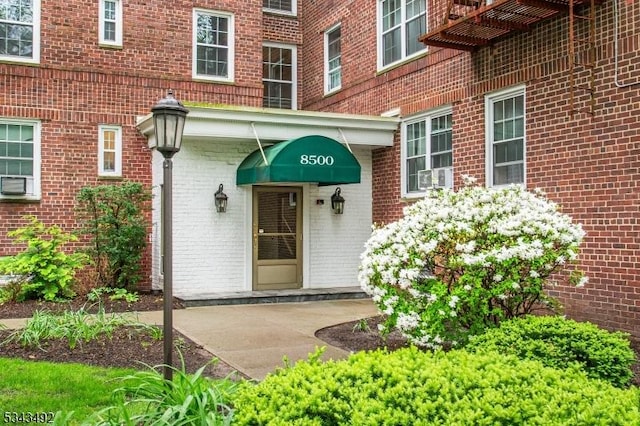 doorway to property with brick siding