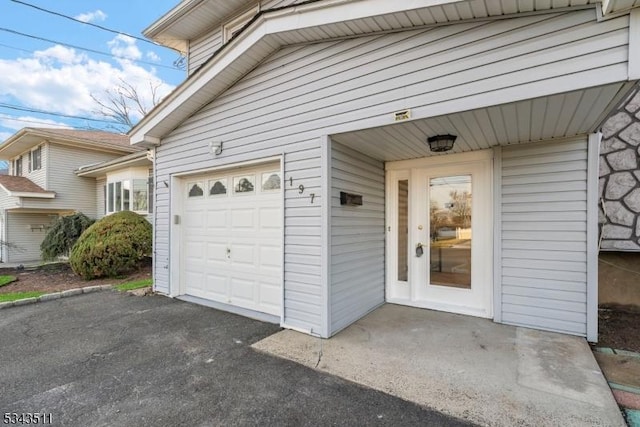 property entrance featuring an attached garage