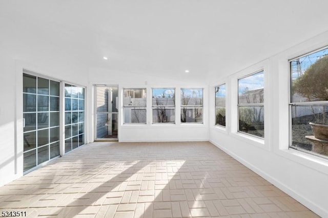 unfurnished sunroom with vaulted ceiling