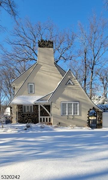 view of front of home featuring a chimney