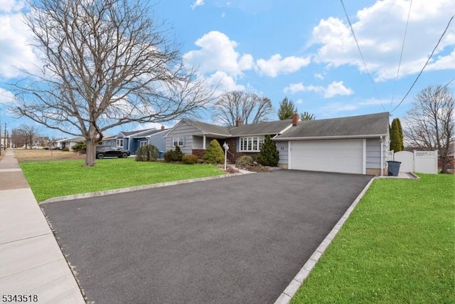 ranch-style house featuring aphalt driveway, a front lawn, a garage, and fence