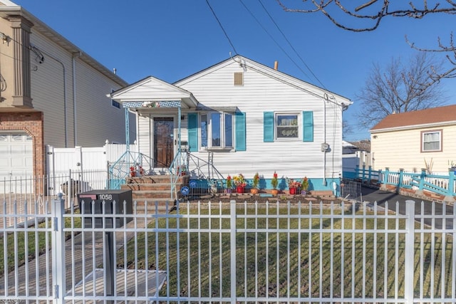 bungalow-style house featuring a fenced front yard and a gate