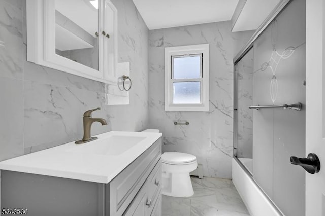 full bath featuring marble finish floor, tub / shower combination, vanity, and toilet