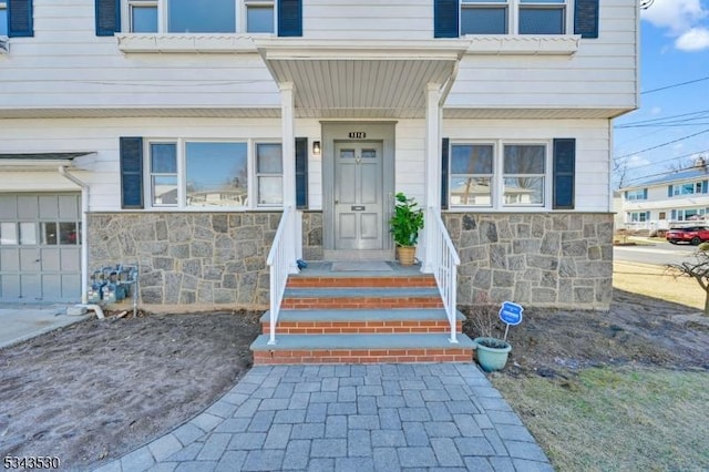 entrance to property featuring stone siding