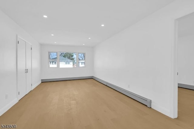 unfurnished bedroom featuring light wood-style flooring, recessed lighting, baseboards, and baseboard heating