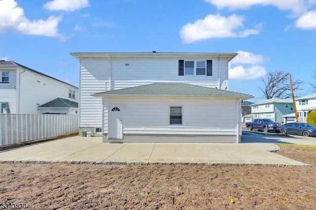 back of property featuring a patio and fence