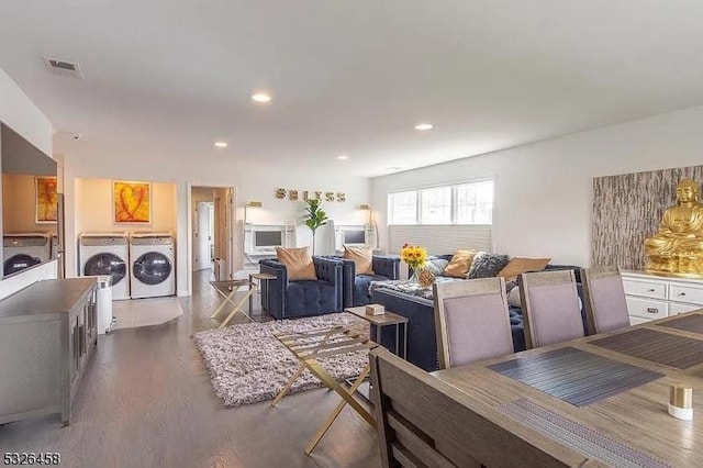 living area with recessed lighting, visible vents, wood finished floors, and washer and clothes dryer