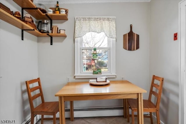 tiled dining room with a baseboard radiator