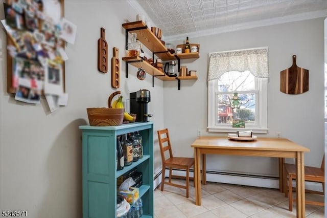 dining room with light tile patterned floors, baseboard heating, and crown molding