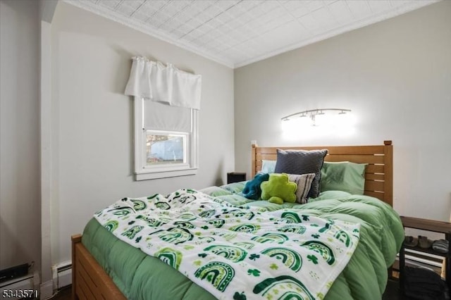 bedroom with a baseboard radiator and crown molding