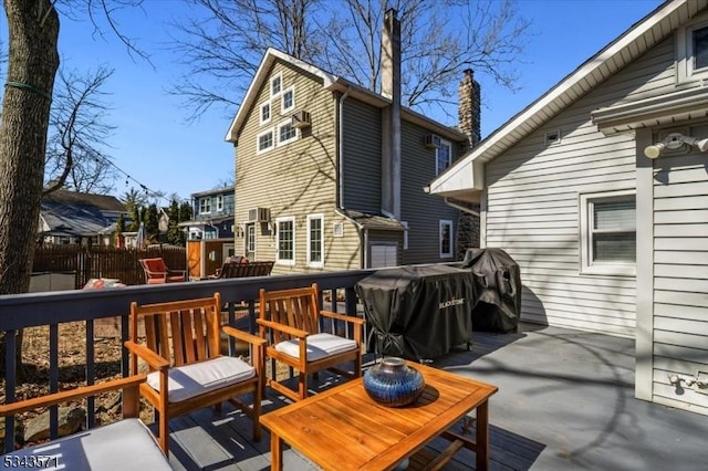 deck with a grill and fence