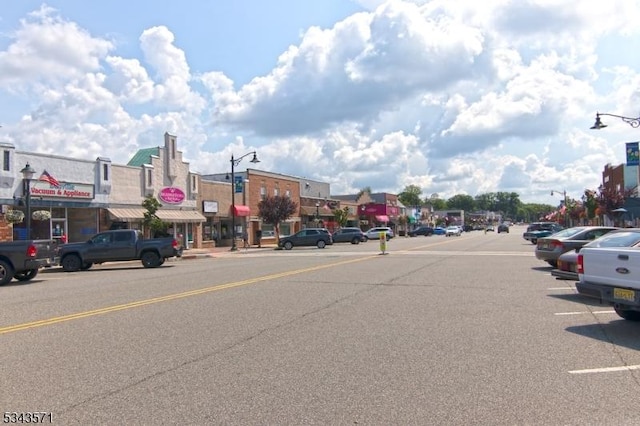 view of road with curbs, street lighting, and sidewalks