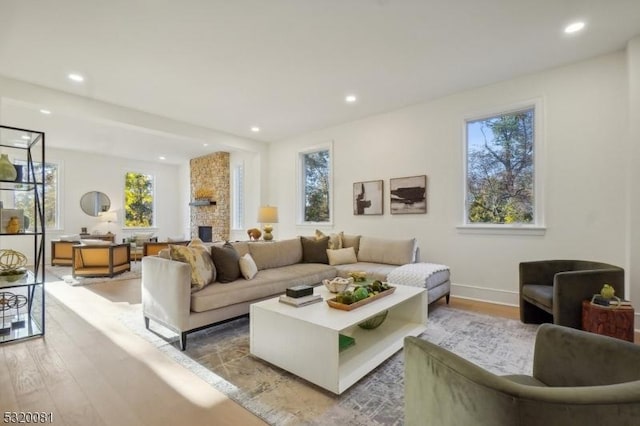 living area featuring a fireplace, recessed lighting, and wood finished floors