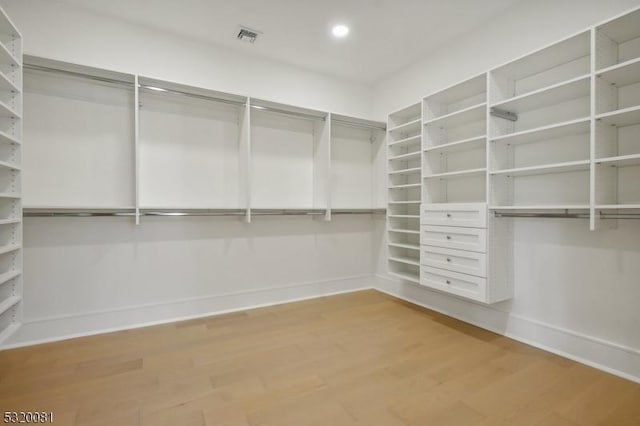 spacious closet featuring visible vents and light wood-style floors