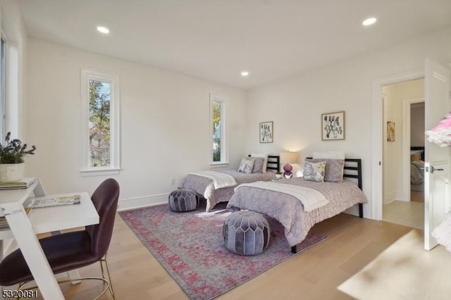 bedroom featuring wood finished floors, recessed lighting, and baseboards