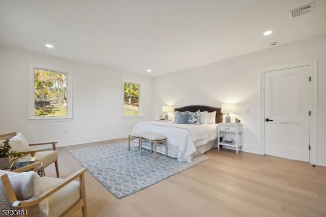 bedroom featuring recessed lighting, light wood-style floors, visible vents, and baseboards