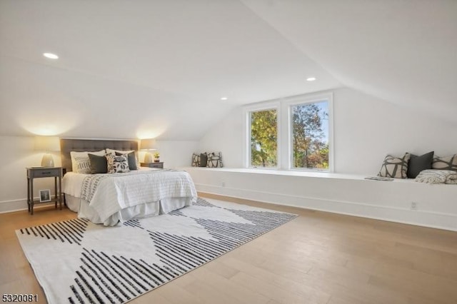 bedroom featuring recessed lighting, baseboards, lofted ceiling, and wood finished floors