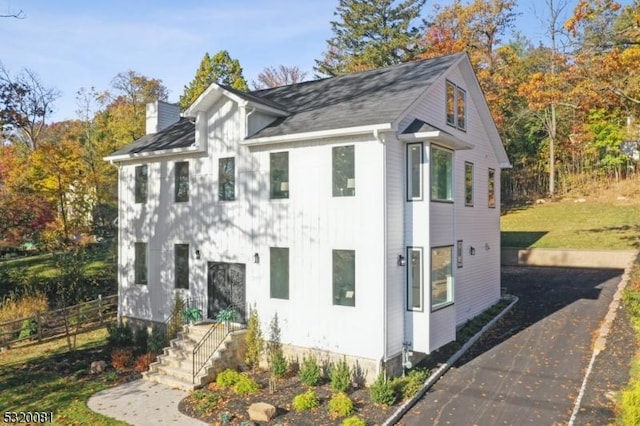 view of home's exterior featuring fence and a chimney