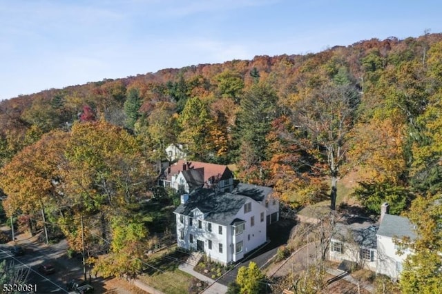 aerial view featuring a wooded view