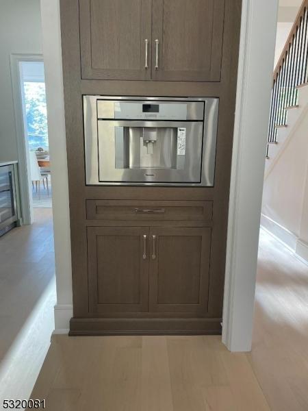 room details featuring stainless steel oven and baseboards