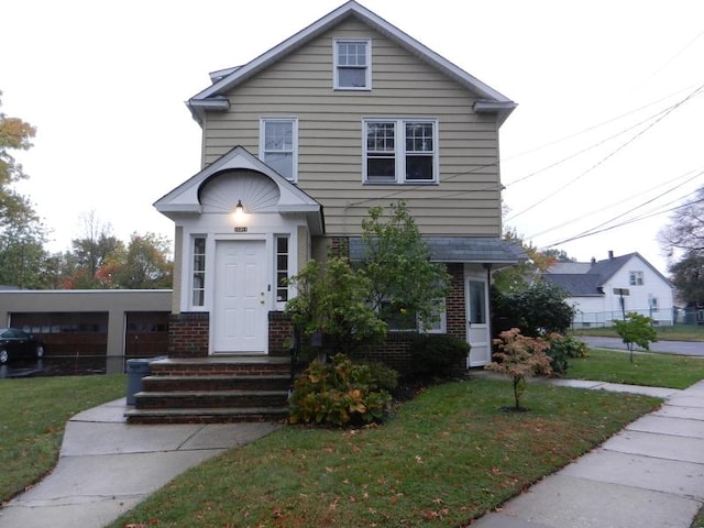 traditional-style house with brick siding and a front yard